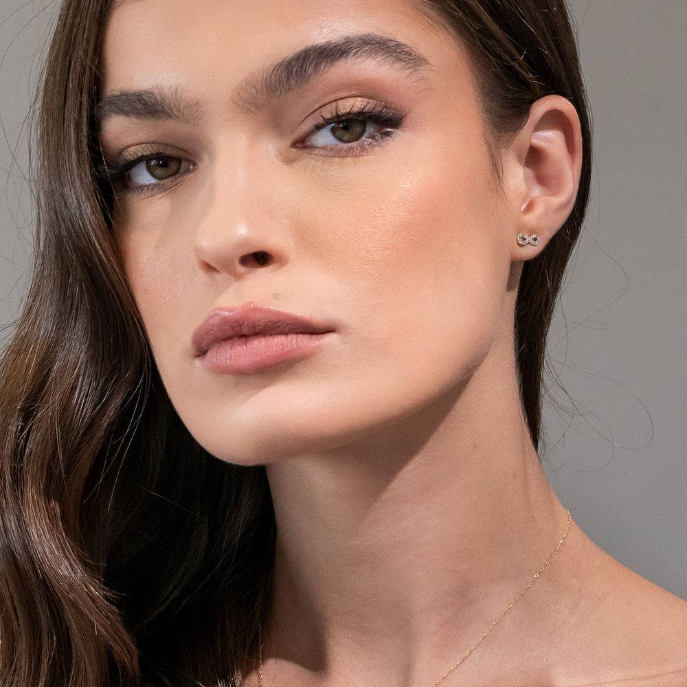 test 1/10 CT. T.W. Diamond Infinity Stud Earrings in 10k Yellow Gold-2 product photo