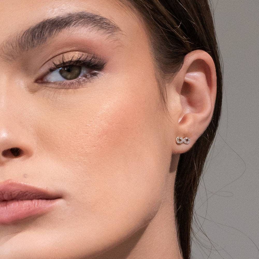 test 1/10 CT. T.W. Diamond Infinity Stud Earrings in 10k Yellow Gold-3 product photo